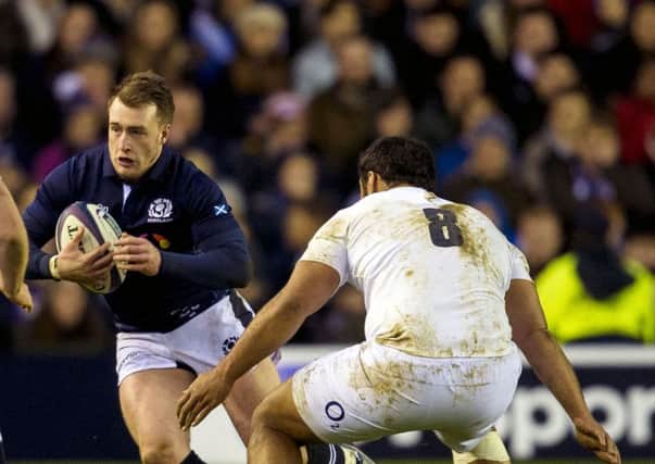 Stuart Hogg tries to find a way past England No 8 Billy Vunipola on Saturday. Picture: SNS
