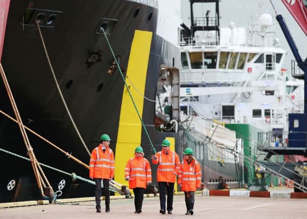 David Cameron talks to Totals managing director for the UK, Elisabeth Proust, as he tours Aberdeen harbour. Picture: Getty