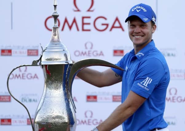 Danny Willett with the trophy after his victory in the 2016 Dubai Desert Classic. Picture: Karim Sahib/AFP/Getty Images