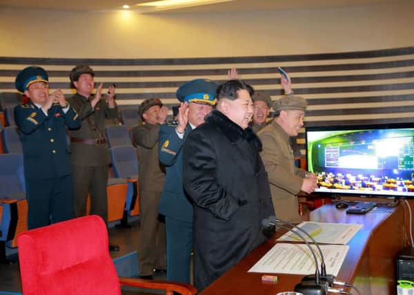 Supreme ruler Kim Jong-un and his top officials celebrate lift-off of the long-range ballistic missile, which has sparked calls for more sanctions against Pyongyang. Picture: Getty