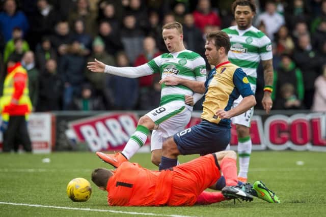 Celtic's Leigh Griffiths (left) puts pressure on the East Kilbride defence. Picture: SNS