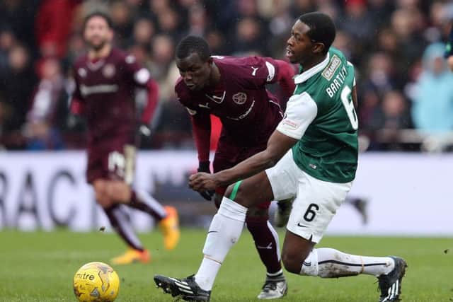 Hibs' Marvin Bartley challenges Hearts' Abiola Dauda. Pic: PA