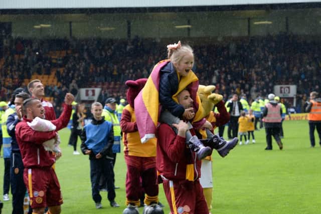 Motherwell players celebrate after maintaining the club's top flight status. Picture: Alan Watson