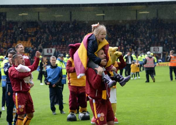 Motherwell players celebrate after maintaining the club's top flight status. Picture: Alan Watson