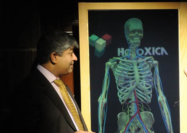 Holoxica founder Javid Khan demonstrates one of the firm's displays. Picture: Greg Macvean