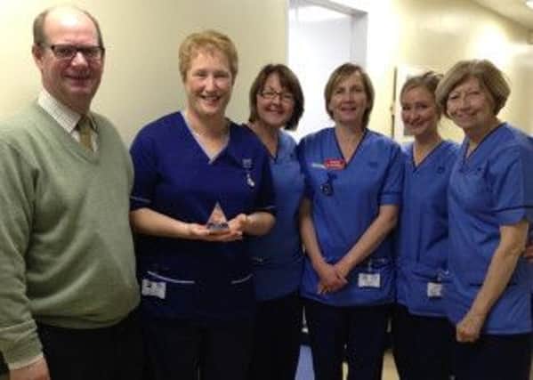 Senior charge nurse Rhoda Patterson with her oncology team and NHS Highland chairman Garry Coutts