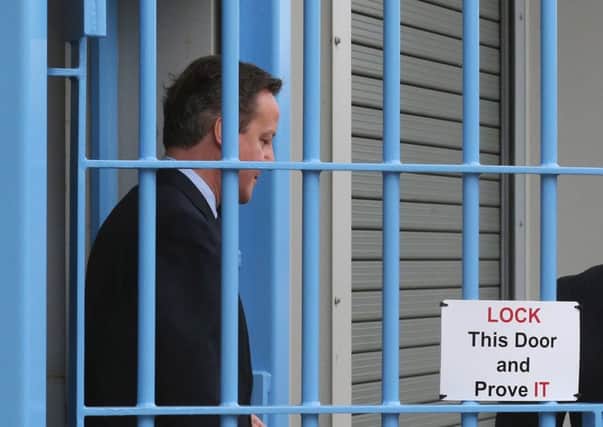 David Cameron, who toured a prison yesterday, said Brexit enthusiasts had questions to answer. Picture: Getty Images