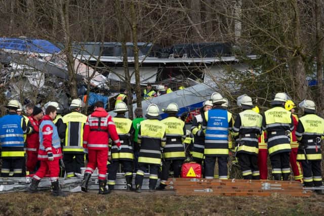 Firefighters and emergency doctors work at the site of the train crash. Picture: AFP/Getty Images