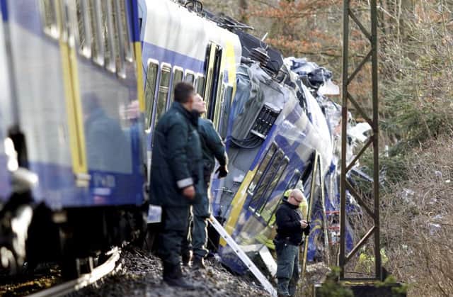 Police stand beside the two trains that collided head-on near Bad Aibling, southern Germany. Picture: dpa/AP