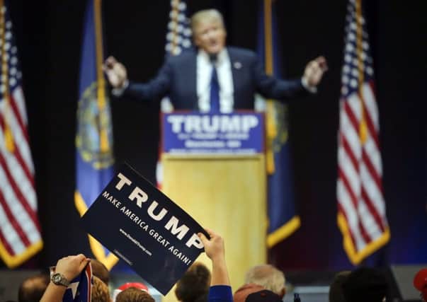 A supporter holds up a poster backing Donald Trump. Picture: AP