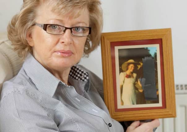 Julie Hambleton holds a picture of her sister Maxine, a Birmingham pub bombing victim. Picture: Newsteam