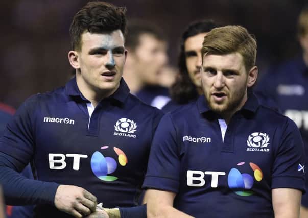 A dejected Matt Scott, left, and Finn Russell after the defeat by England.

 Picture Ian Rutherford
