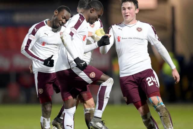 Abiola Dauba's Hearts team-mates celebrate with the striker. Picture: SNS