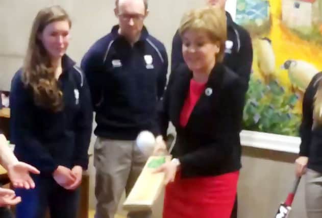 Nicola Sturgeon shows off her technique with a bat and ball at Holyrood. Picture: twitter/scotgovfm