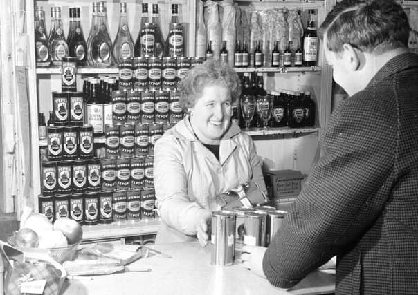 A customer stocks up for Hogmanay in HJ Hildersley Licensed Grocer.