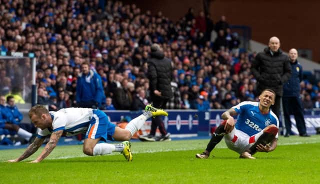 Tavernier, right, hits the deck after a foul by Kallum Higginbotham. Picture: SNS