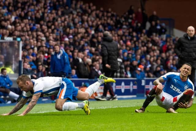 Tavernier, right, hits the deck after a foul by Kallum Higginbotham. Picture: SNS