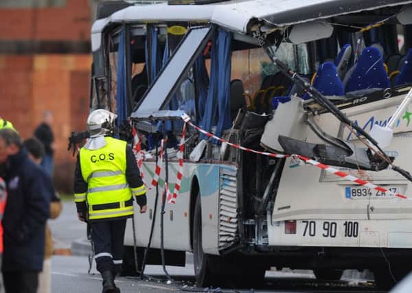 French police examine the wreckage of a school bus in which six pupils died after part of a lorry sliced through the vehicle. Picture: AFP/Getty Images