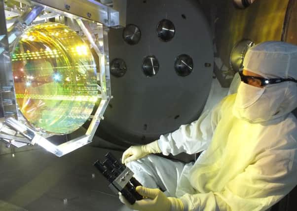 A technician inspects one of the Laser Interferometer Gravitational Wave Observatory's (LIGO) core optics (mirrors). Picture: AFP