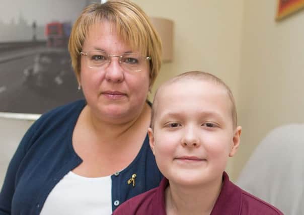 Toby Etheridge with his mum Alison. Picture: Steven Brown