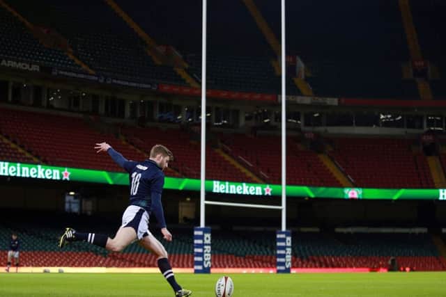 Finn Russell takes time at training to practise his place-kicking prior to todays match against Wales at the Principality Stadium. Picture: PA