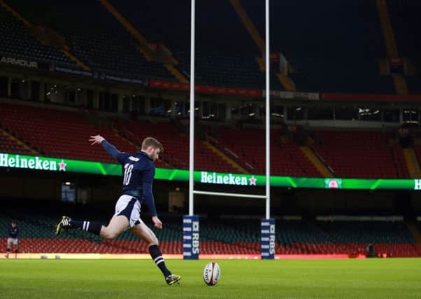 Finn Russell takes time at training to practise his place-kicking prior to todays match against Wales at the Principality Stadium. Picture: PA
