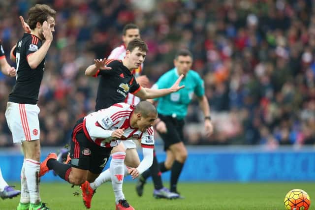 Manchester United's Donald Love, centre, tackles Wahbi Khazri of Sunderland. Picture: Clive Brunskill/Getty Images