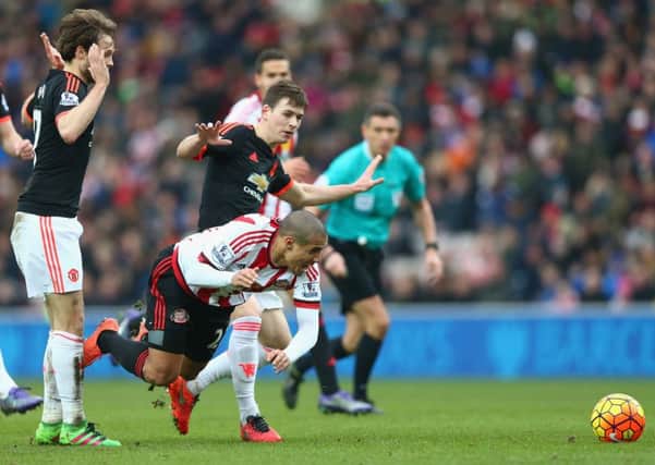 Manchester United's Donald Love, centre, tackles Wahbi Khazri of Sunderland. Picture: Clive Brunskill/Getty Images