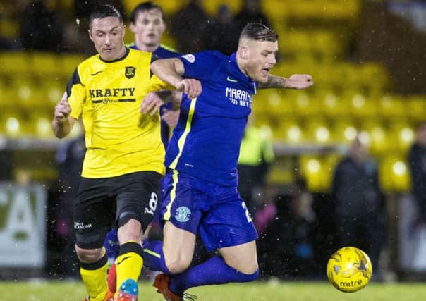 Hibs' Anthony Stokes is tackled by Livingston's Mark Fotheringham. Picture: Ross Parker/SNS