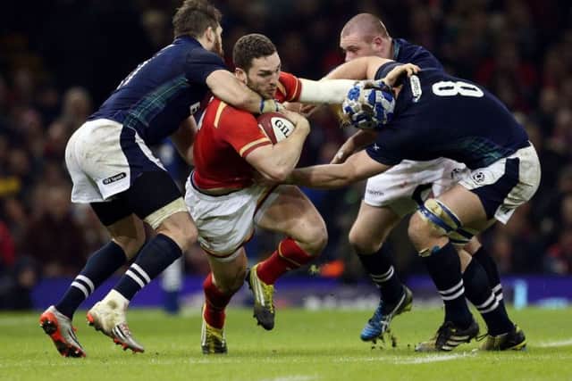 Wales' George North is tackled by Scotland's Tommy Seymour and David Denton. Picture: David Davies/PA Wire