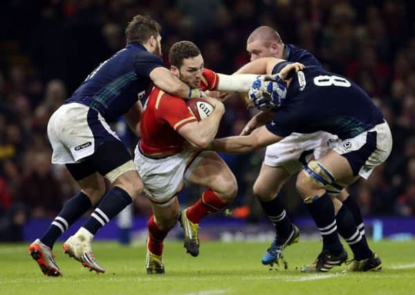 Wales' George North is tackled by Scotland's Tommy Seymour and David Denton. Picture: David Davies/PA Wire