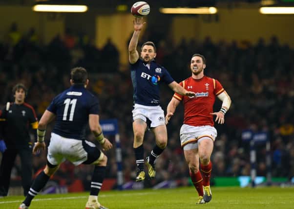 Scotland captain Greig Laidlaw taps the ball back to team-mate Tommy Seymour. Picture: Stu Forster/Getty Images