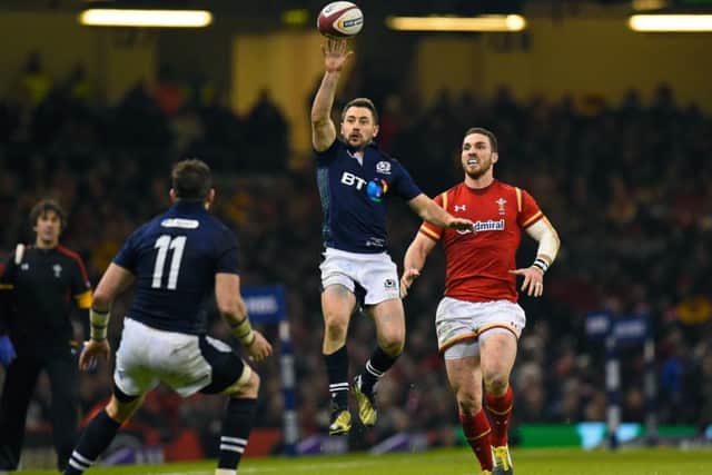Scotland captain Greig Laidlaw taps the ball back to team-mate Tommy Seymour. Picture: Stu Forster/Getty Images