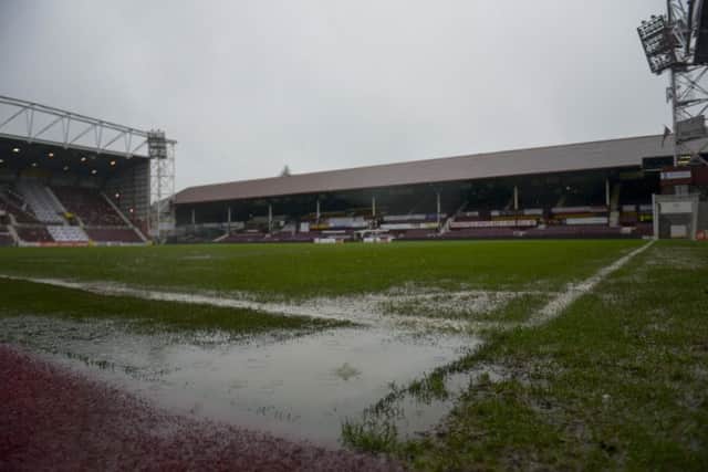 Water collecting on the pitch at Tynecastle prior to the game's postponement. Picture: Andrew O'Brien