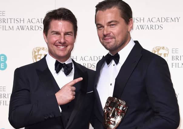 Leonardo DiCaprio (right) holding his BAFTA for Best Award with actor Tom Cruise. Picture: Getty Images