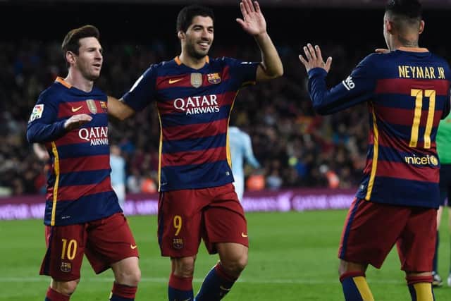 Lionel Messi (left) and Luis Suarez celebrate a goal with fellow forward Neymar. Picture: AFP/Getty Images