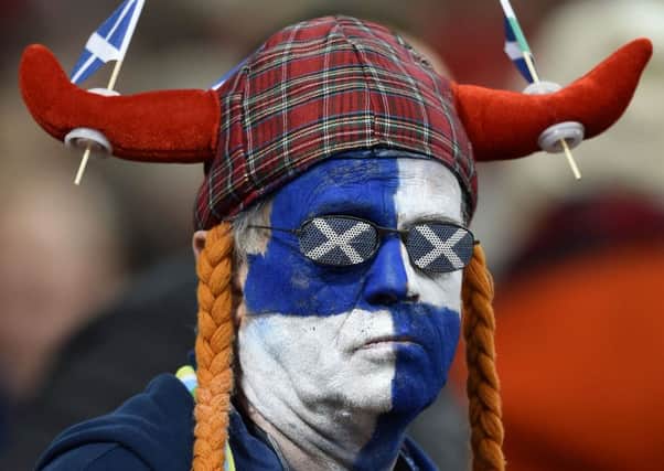 A despondent Scotland fan looks on during the defeat in Cardiff. Picture: PA