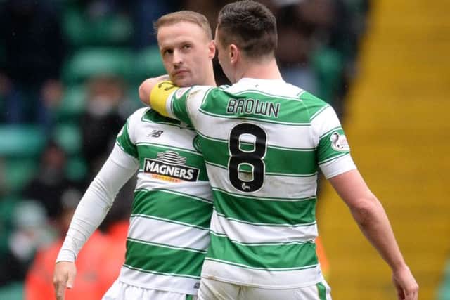 Celtic's Leigh Griffiths (left) celebrates with Scott Brown having opened the scoring against Ross County on Saturday. Picture: SNS