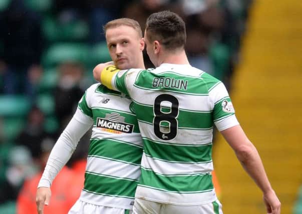 Celtic's Leigh Griffiths (left) celebrates with Scott Brown having opened the scoring against Ross County on Saturday. Picture: SNS