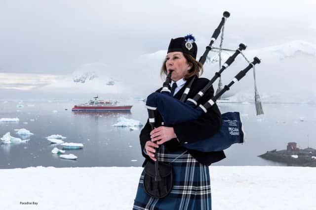 Irene Robinson, a piper who is travelling 50,000 miles to play 12 gigs at famous locations around the world in aid of charity, as she played a unique concert in Paradise Bay, Antarctica. Picture: PA