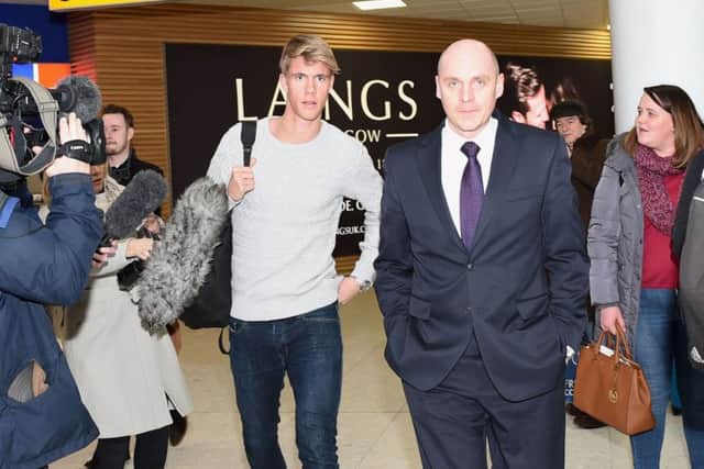 Kristoffer Ajer arrives at Glasgow Airport for talks with Celtic and is escorted by the club's physiotherapist Tim Williamson. Picture: Craig Williamson/SNS