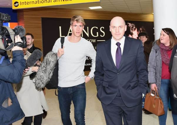 Kristoffer Ajer arrives at Glasgow Airport for talks with Celtic and is escorted by the club's physiotherapist Tim Williamson. Picture: Craig Williamson/SNS