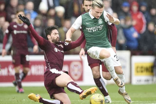 Miguel Pallardo of Hearts and Jason Cummings of Hibs battle for the ball. Picture: Greg Macvean