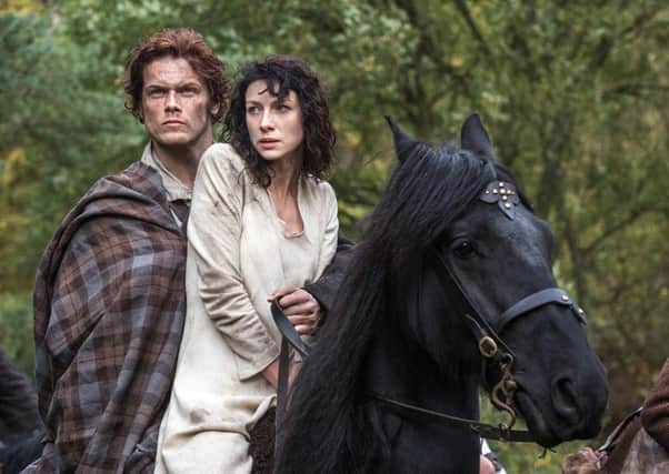 Caitriona Balfe as Claire Randal  and Sam Heughan as Jamie Fraser in Outlander.