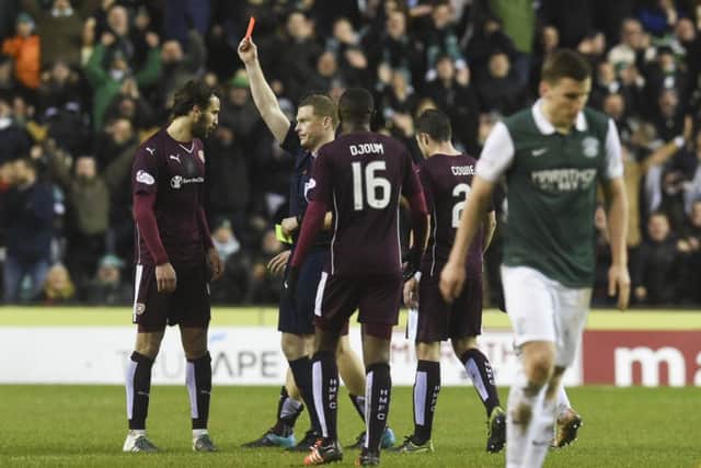 Blazej Augustyn (left) is sent off shortly before Hibs were also reduced to ten men. Picture: SNS
