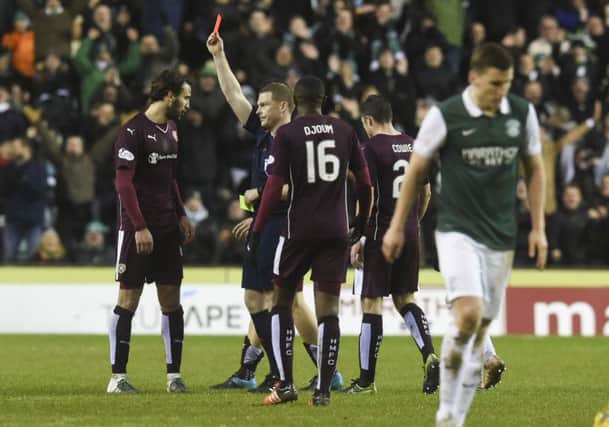Blazej Augustyn (left) is sent off shortly before Hibs were also reduced to ten men. Picture: SNS