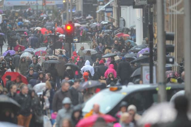 Shoppers brave the stormy weather on Buchanan Street, Glasgow. Picture: Robert Perry