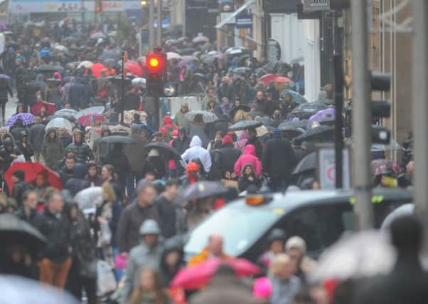 Shoppers brave the stormy weather on Buchanan Street, Glasgow. Picture: Robert Perry