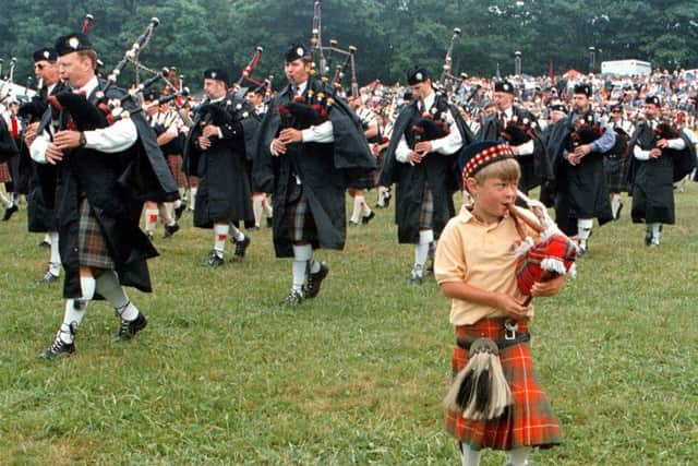 Six-year-old Andrew Warburton of Marion, N.C., plays his bagpipes along with the Grandfather Mountain Highland Pipe Band at the 44th annual Grandfather Mountain Highland Games and Gathering of Scottish Clans, at Grandfather Mountain, near Linville, N.C., Saturday, July 10, 1999. (AP Photo/Alan Marler)