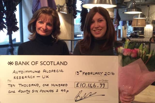 Ruth presents a cheque for Â£10,146.99 to Karen Green, Secretary of AAR-UK